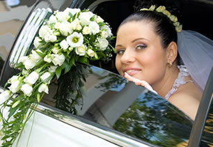 Bride sits in limousine